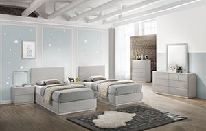 Two modern styled light gray twin beds