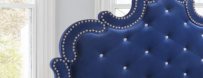 blue fabric tufted bed