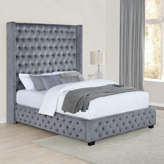 Queen bed upholstered in a gray velvet