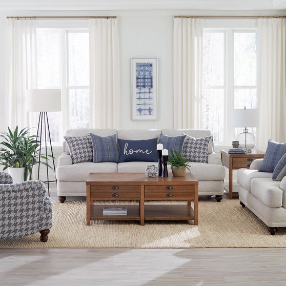 Light gray casual style sofa with blue pillows