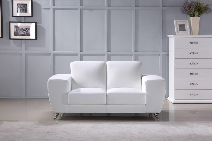 Ultra-contemporary white leather loveseat w/ metal legs by Beverly Hills