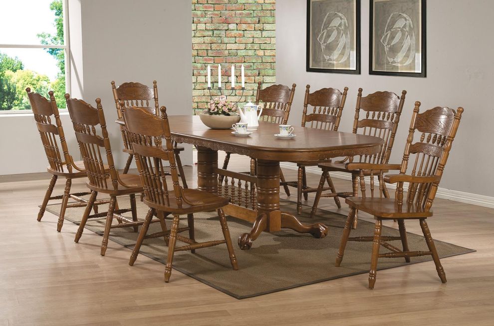 Oval oak dining table with trestle base by Coaster