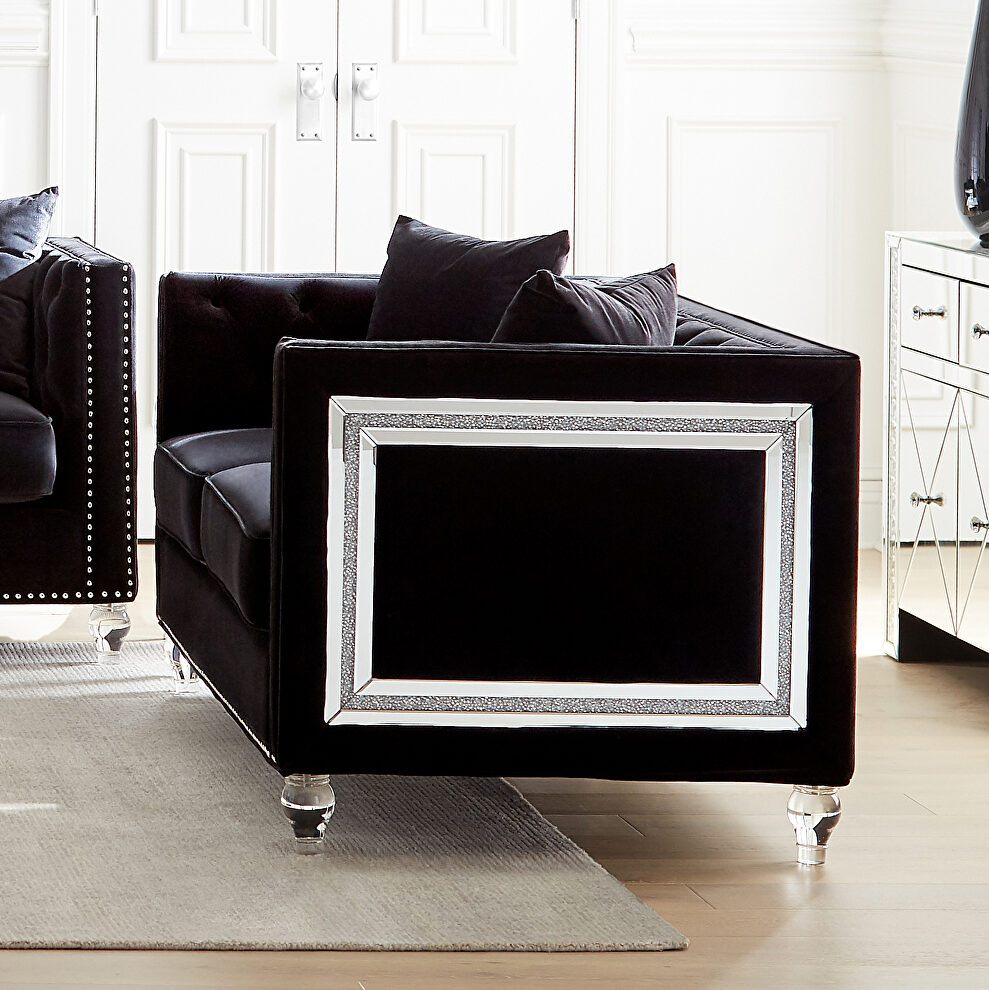 Loveseat upholstered in a luxurious black velvet by Coaster