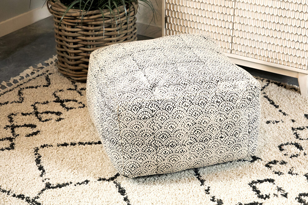Versatile floor pouf covered in a distressed fabric by Coaster