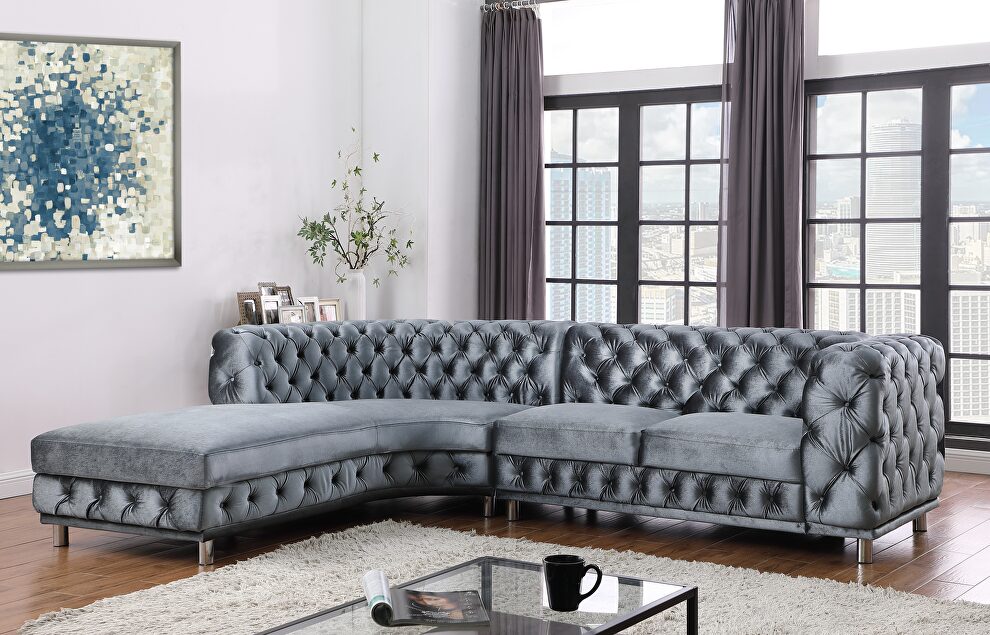Grey sectional in left design with tufted seats and back by Global
