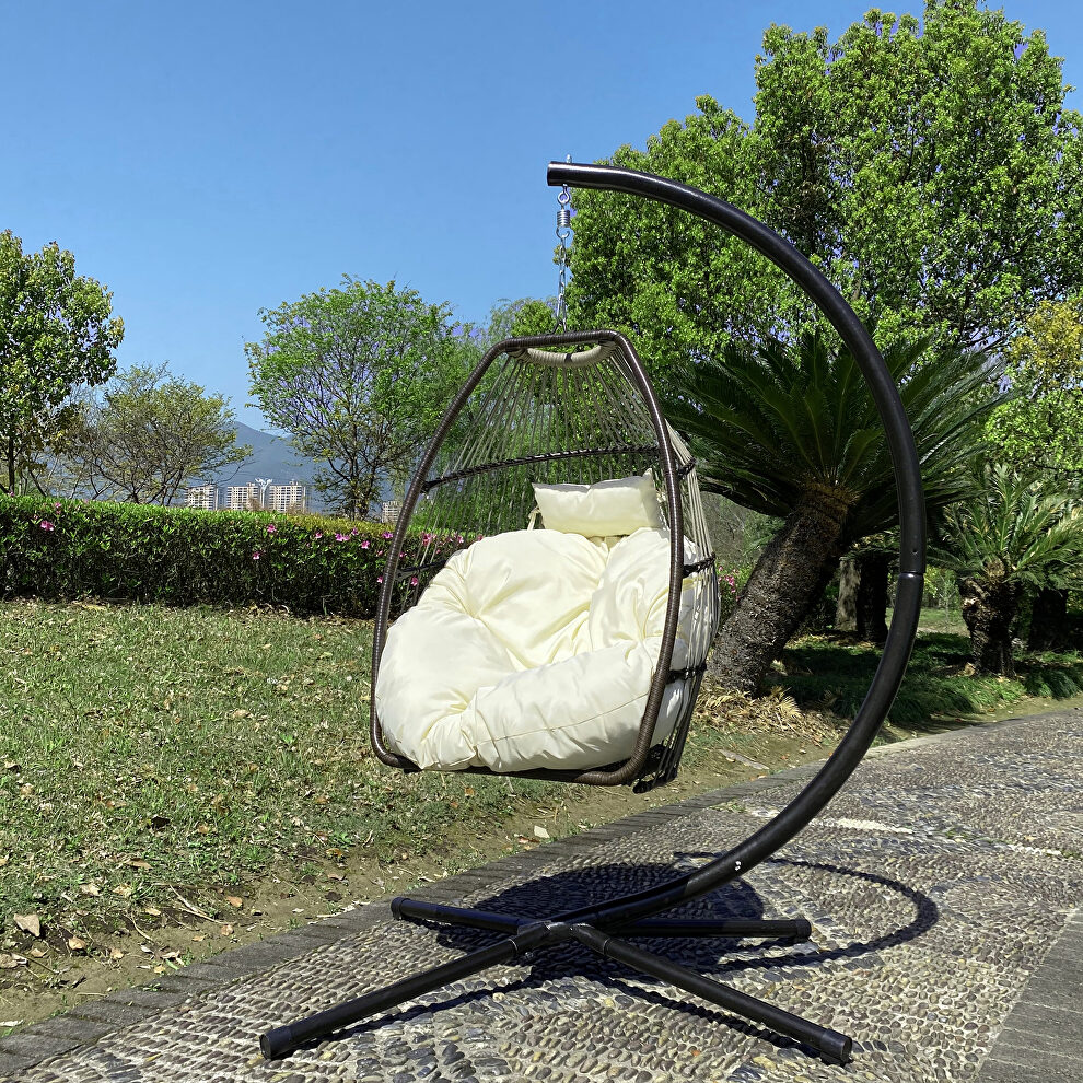 Rattan swing hammock egg chair with beige cushion and pillow by La Spezia