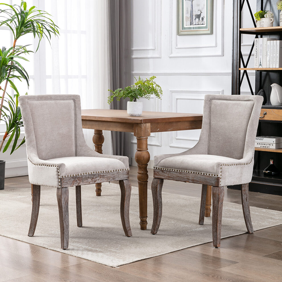 Beige fabric dining chairs with neutrally toned solid wood legs bronze nailhead, set of 2 by La Spezia