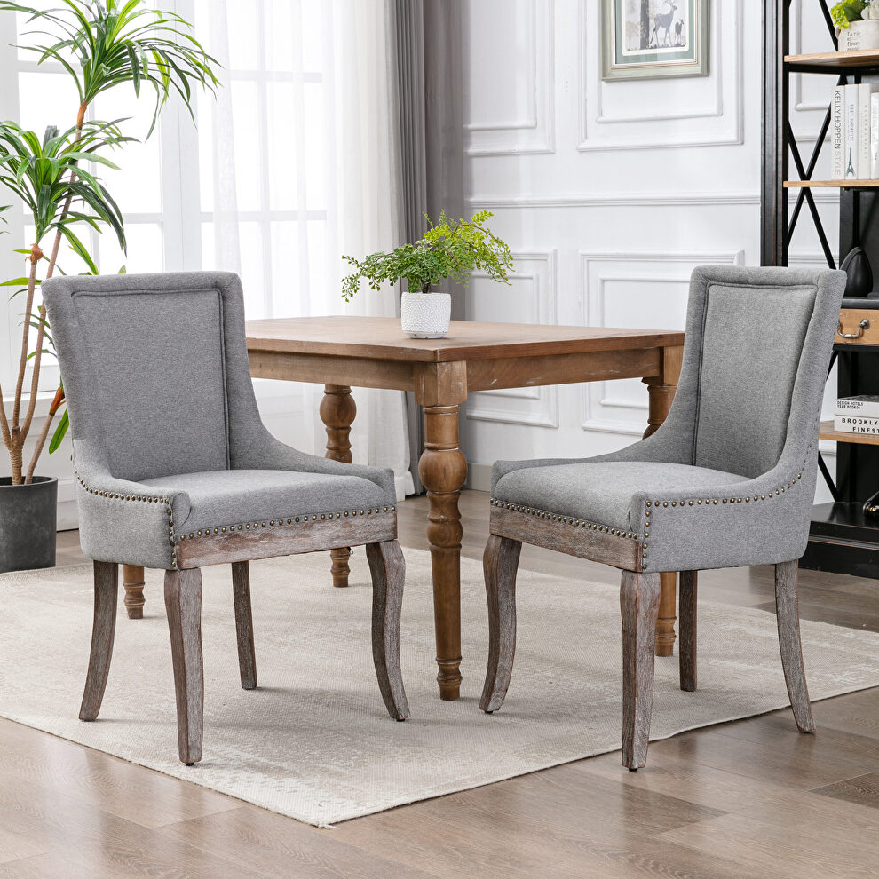 Gray fabric dining chairs with neutrally toned solid wood legs bronze nailhead, set of 2 by La Spezia