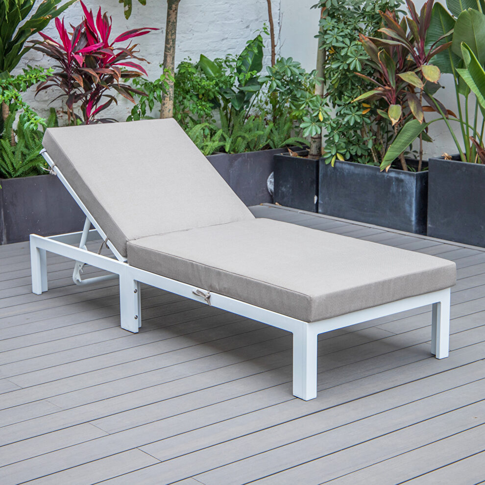 Modern outdoor white chaise lounge chair with beige cushions by Leisure Mod