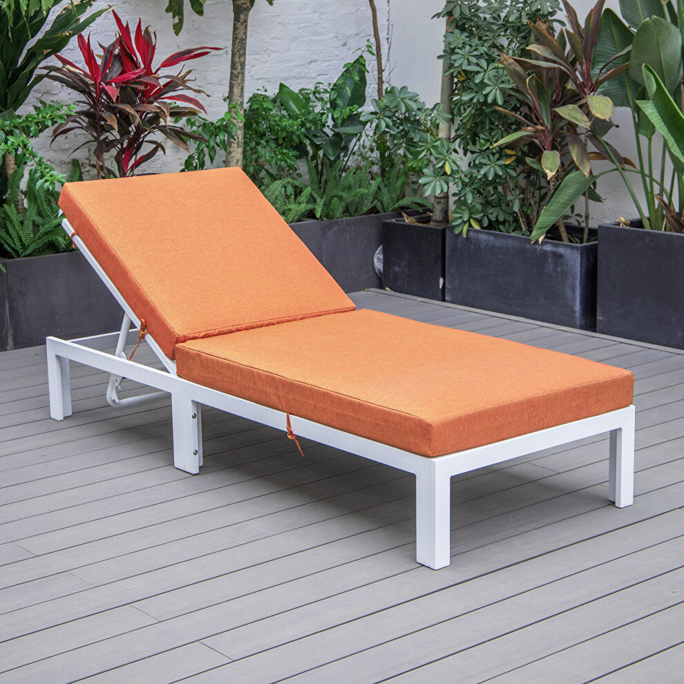 Modern outdoor white chaise lounge chair with orange cushions by Leisure Mod