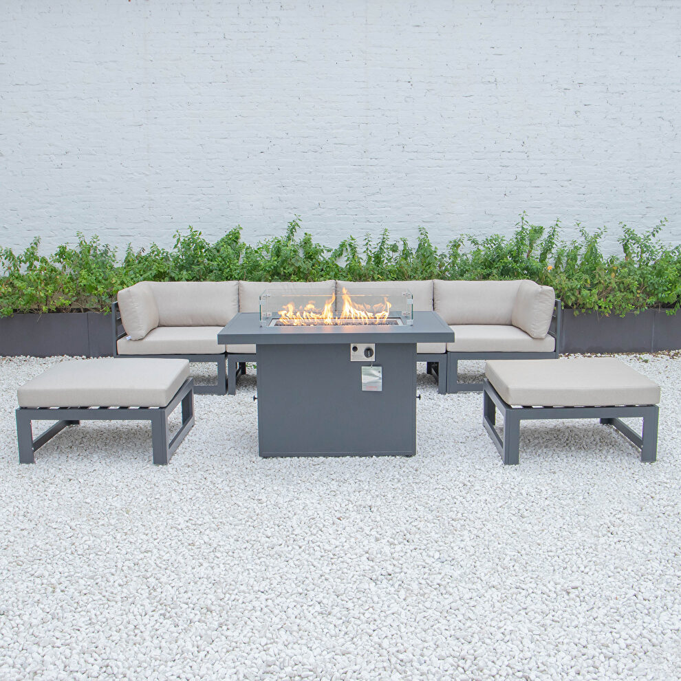 Beige cushions 7-piece patio ottoman sectional and fire pit table black aluminum by Leisure Mod