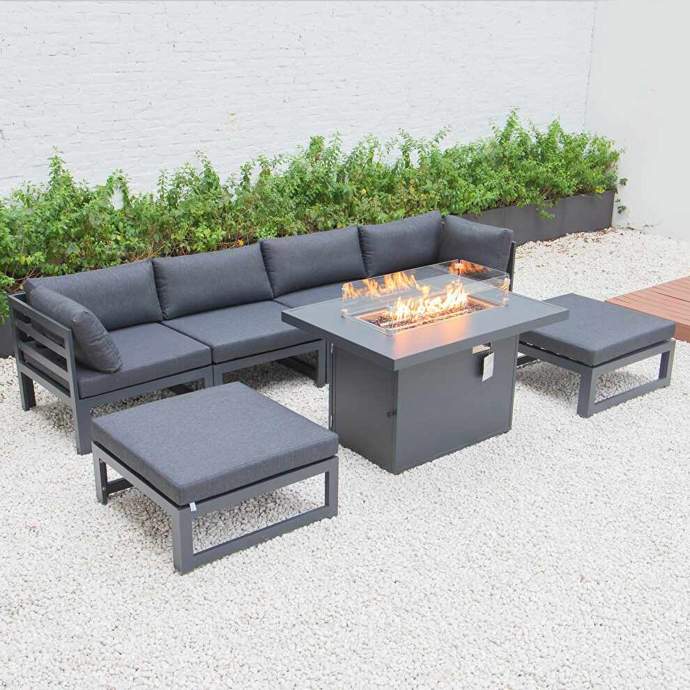 Black cushions 7-piece patio ottoman sectional and fire pit table black aluminum by Leisure Mod