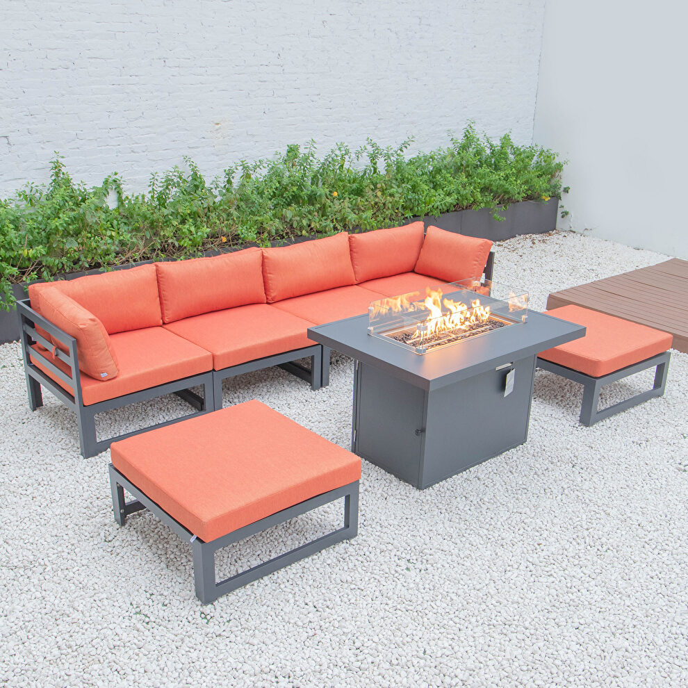 Orange cushions 7-piece patio ottoman sectional and fire pit table black aluminum by Leisure Mod