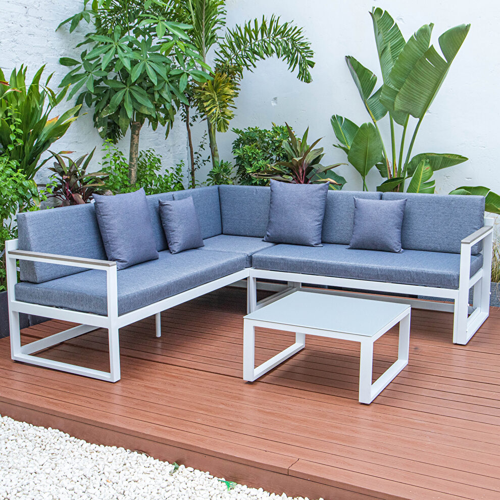 Blue cushions and white base sectional with adjustable headrest & coffee table by Leisure Mod