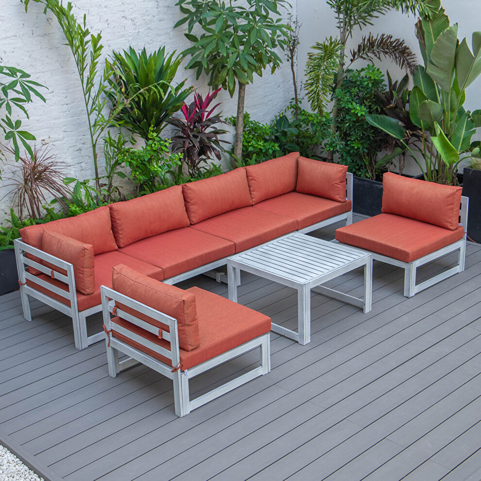 Orange finish cushions 7-piece patio sectional and coffee table set in weathered gray aluminum by Leisure Mod