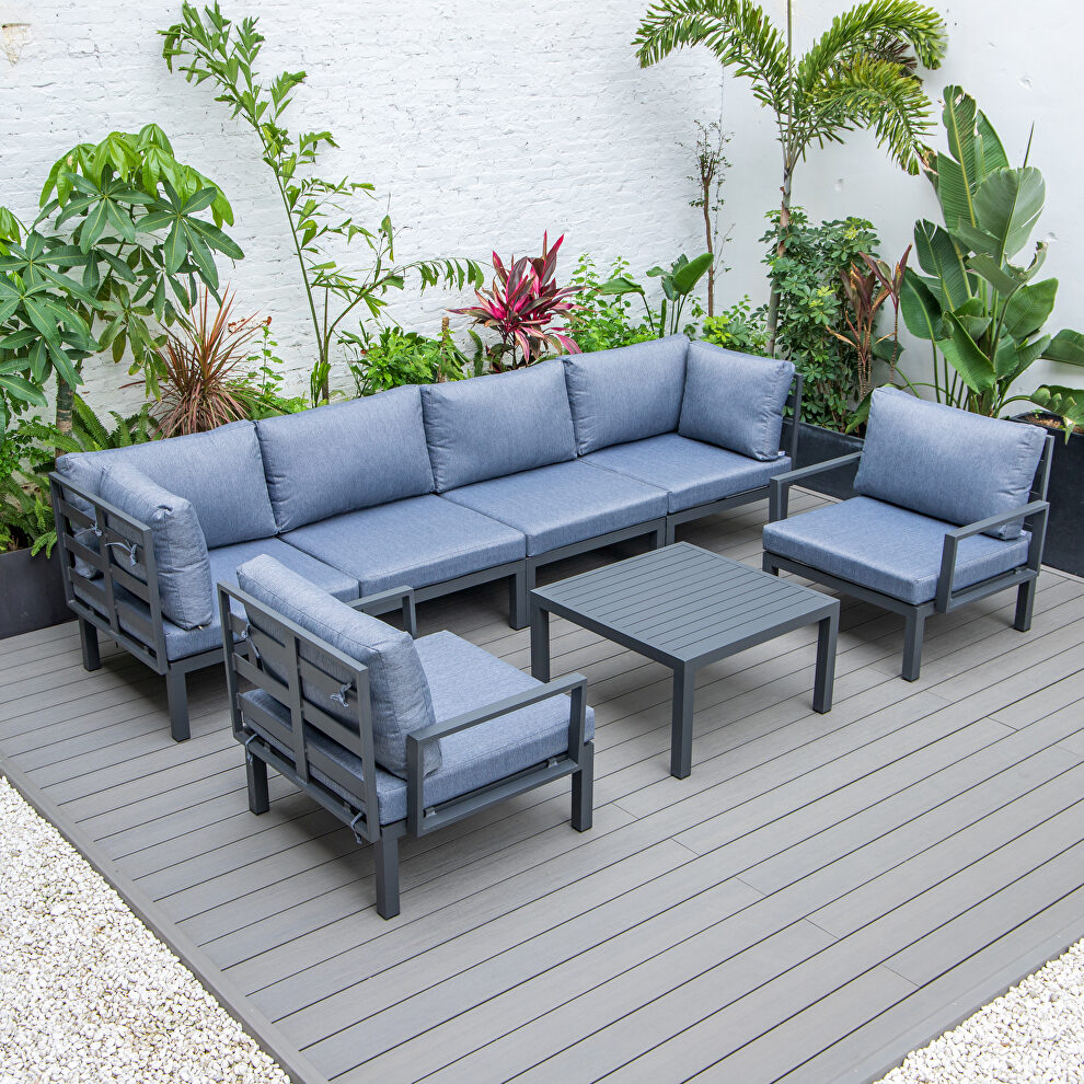7-piece aluminum patio conversation set with coffee table and charcoal blue cushions by Leisure Mod