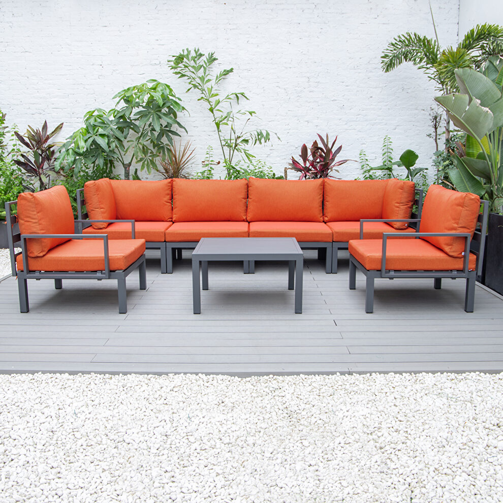 7-piece aluminum patio conversation set with coffee table and orange cushions by Leisure Mod