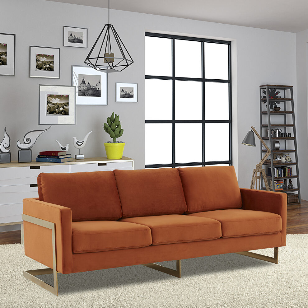 Modern mid-century upholstered orange marmalade velvet sofa with gold frame by Leisure Mod