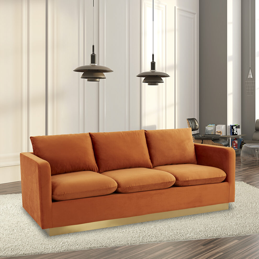 Modern style upholstered orange marmalade velvet sofa with gold frame by Leisure Mod