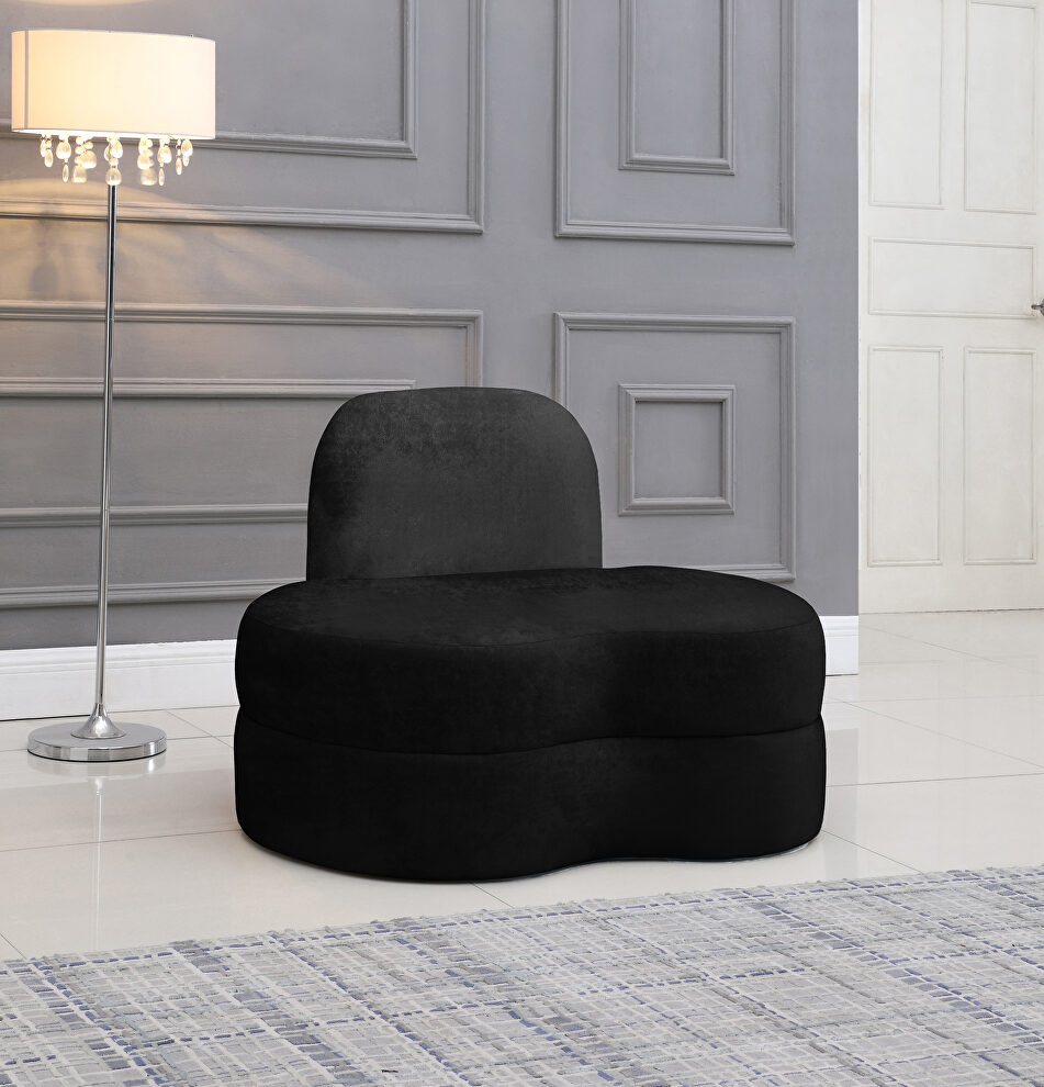 Kidney-shaped lounge style black velvet chair by Meridian