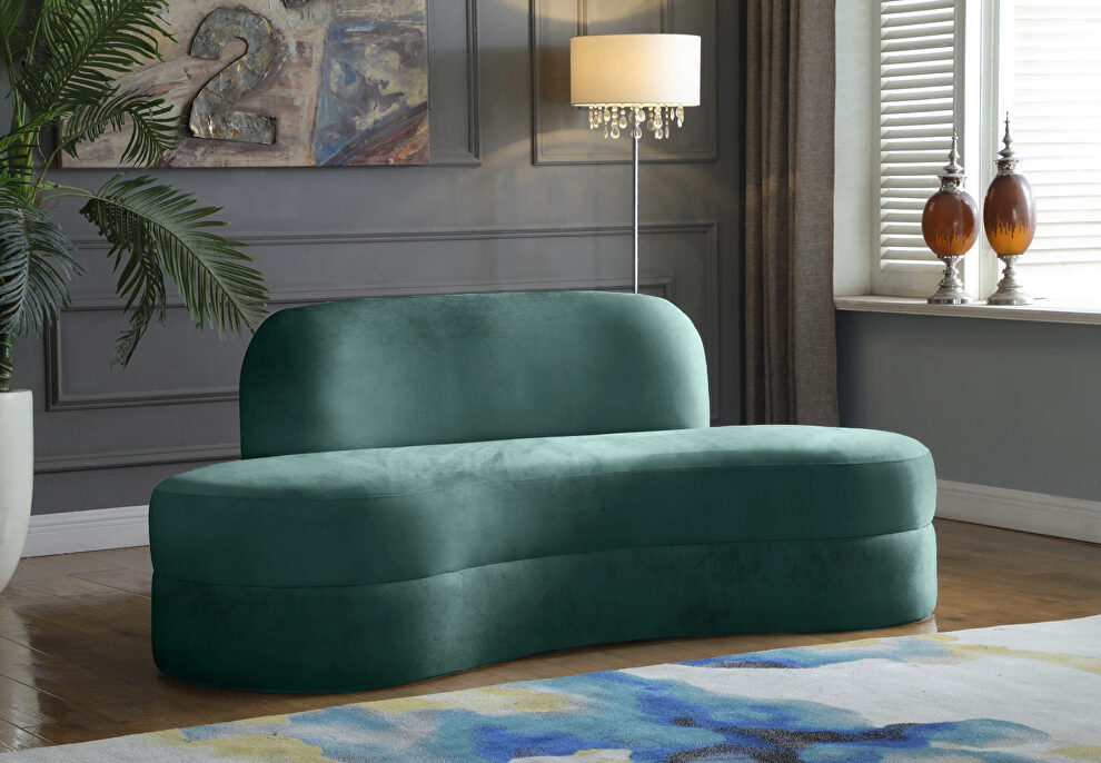 Kidney-shaped lounge style green velvet sofa by Meridian