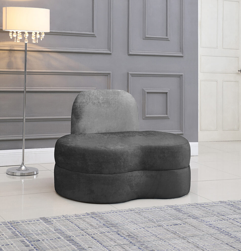 Kidney-shaped lounge style gray velvet chair by Meridian