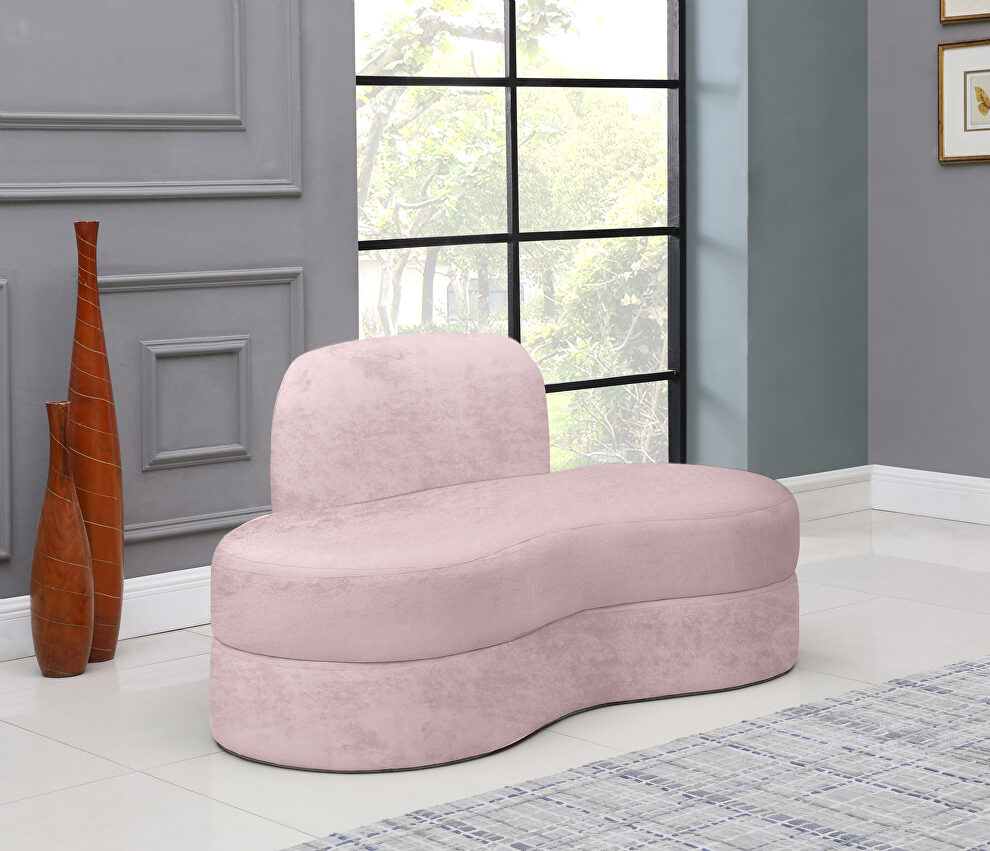 Kidney-shaped lounge style pink velvet loveseat by Meridian