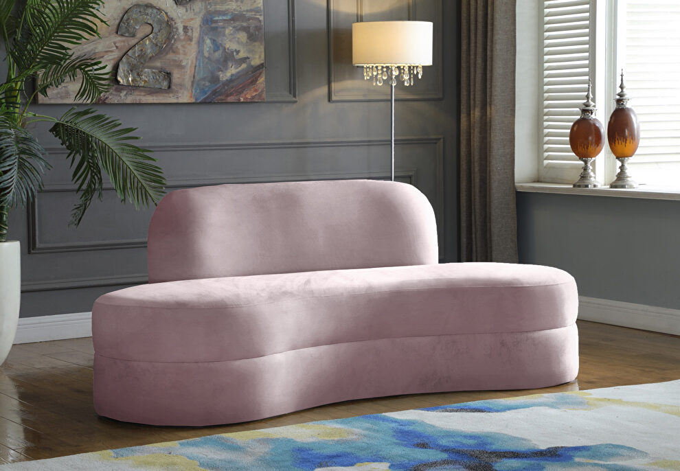 Kidney-shaped lounge style pink velvet sofa by Meridian