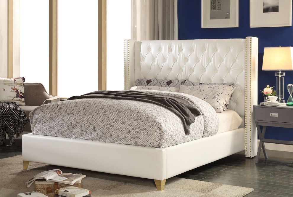 White tufted bonded leather wing design bed by Meridian