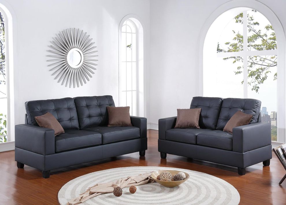 Black faux leather sofa and loveseat set by Poundex
