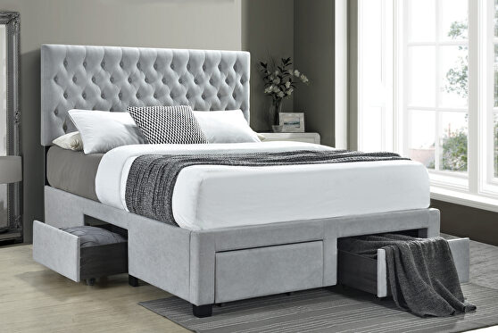 Queen storage bed upholstered in a light gray fabric