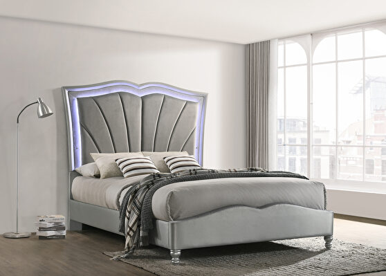 Queen bed upholstered in a light gray velvet fabric
