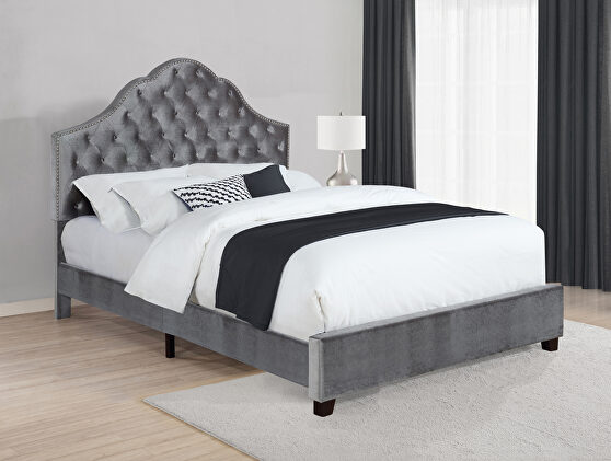 Queen slat bed upholstered in a gray velvet
