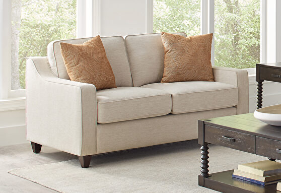 Loveseat, upholstered in soft low pile textured beige chenille