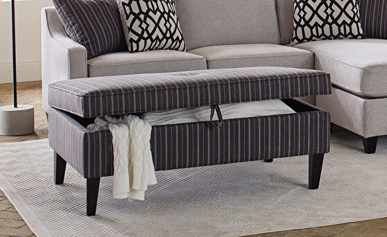 Storage ottoman upholstered in a fashionable black and white pin stripe