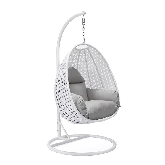 Light gray cushion and white wicker hanging egg swing chair