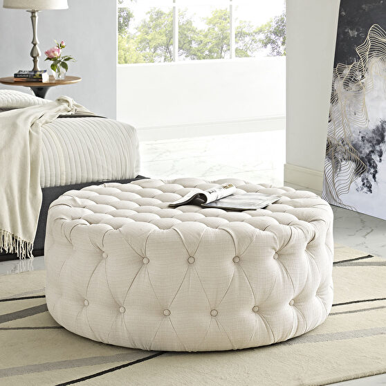 Upholstered fabric ottoman in beige