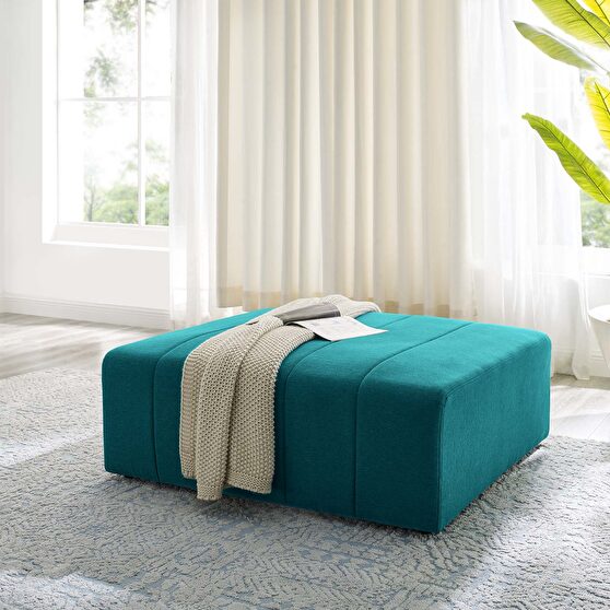 Upholstered fabric ottoman in teal