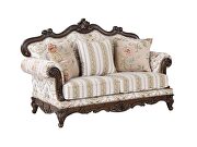 Pattern fabric upholstery & walnut finish base scrolled floral loveseat