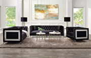 Black velvet upholstery and button tufted mirrored trim accent sofa