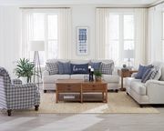 Light gray casual style sofa with blue pillows