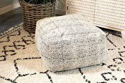 Versatile floor pouf covered in a distressed fabric main photo