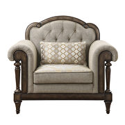 Neutral hued brown fabric chair with 1 pillow
