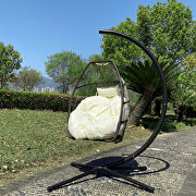 Rattan swing hammock egg chair with beige cushion and pillow