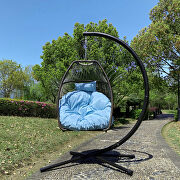 Rattan swing hammock egg chair with blue cushion and pillow