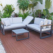 Light gray cushions and black base sectional with adjustable headrest & coffee table