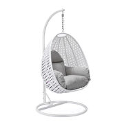 Light gray cushion and white wicker hanging egg swing chair