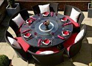 Black 7-piece rattan outdoor dining set with red and white cushions main photo