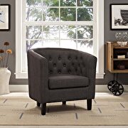 Upholstered fabric armchair in brown
