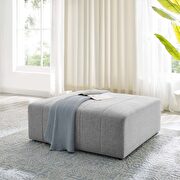 Upholstered fabric ottoman in light gray